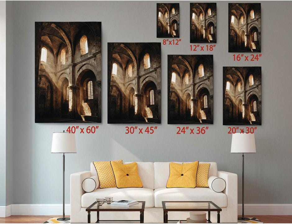 a living room with a white sofa and a coffee table. Above the sofa, there are six framed photographs of the same architectural structure, likely a church, displayed in various sizes. The photographs are arranged in a grid-like pattern, with each photograph having a corresponding size indicated below it.