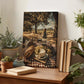 a wooden table with a painting of a picnic scene, including a bottle of wine, grapes, bread, and cheese, surrounded by potted plants and books.