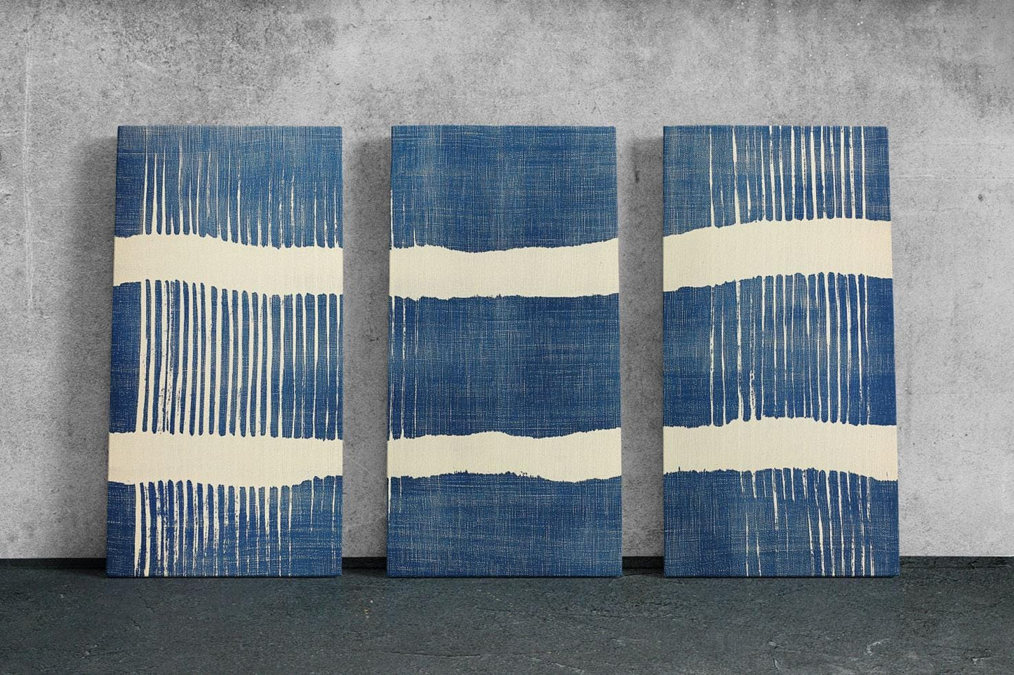 three blue and white paintings on a wall