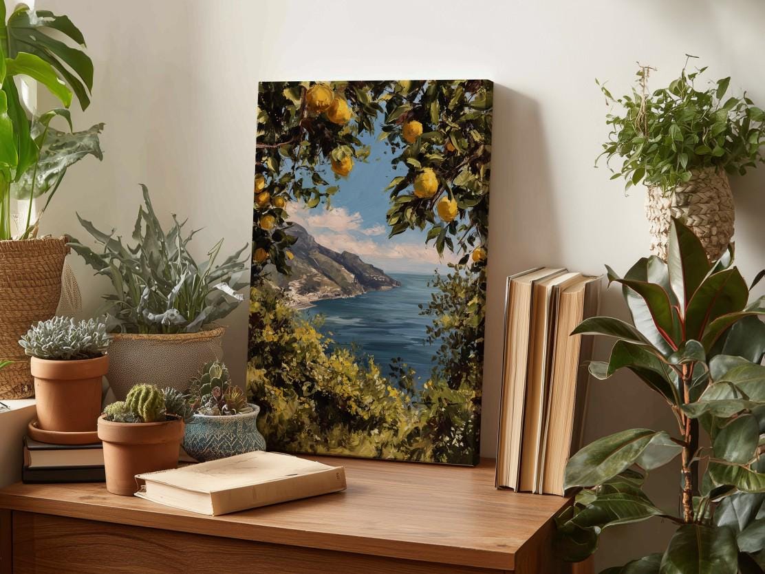 a wooden table with a painting of a scenic coastal landscape, surrounded by potted plants and books, creating a cozy and inviting atmosphere.