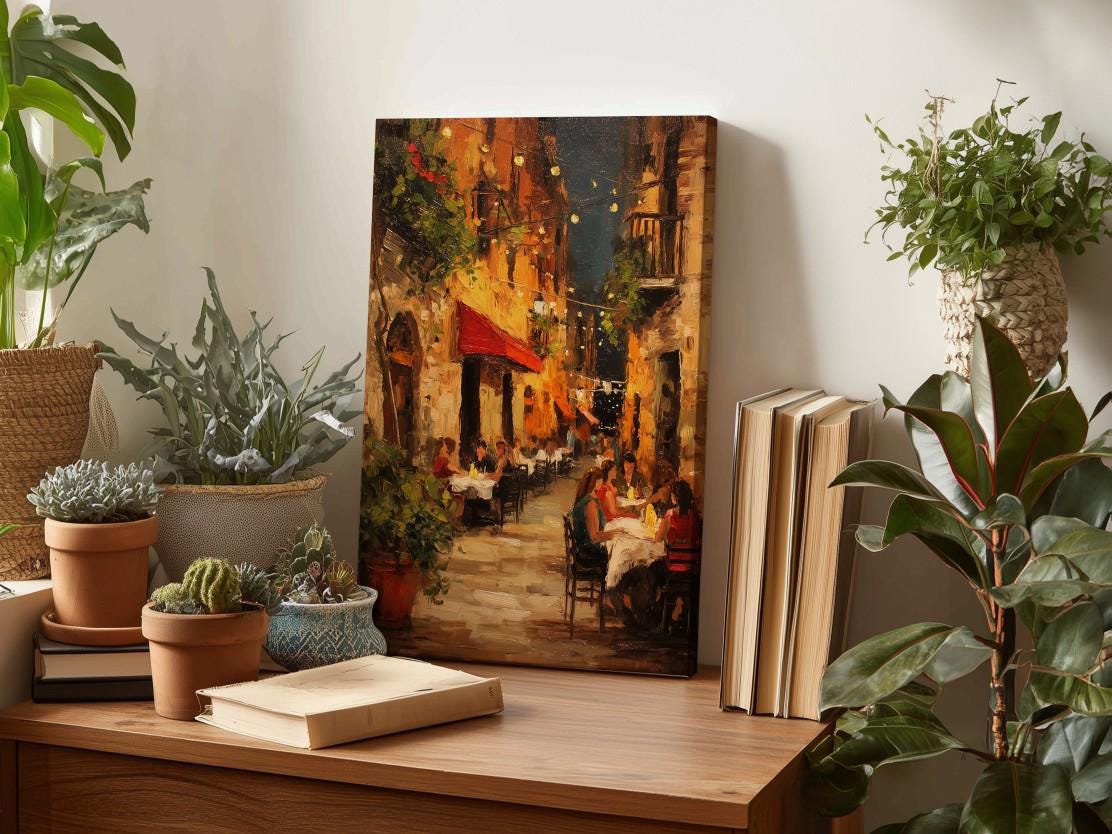 a wooden table with a painting of a street scene, surrounded by potted plants and books, creating a cozy and inviting atmosphere.