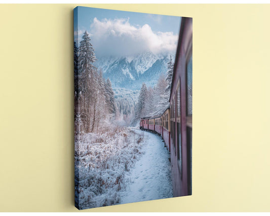 A red train travels through a snowy mountain landscape, with snow-covered trees and a cloudy sky in the background.