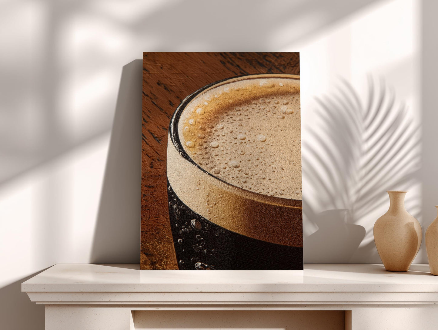 A close-up view of a glass of beer with a foamy head, placed on a white shelf next to two small vases.