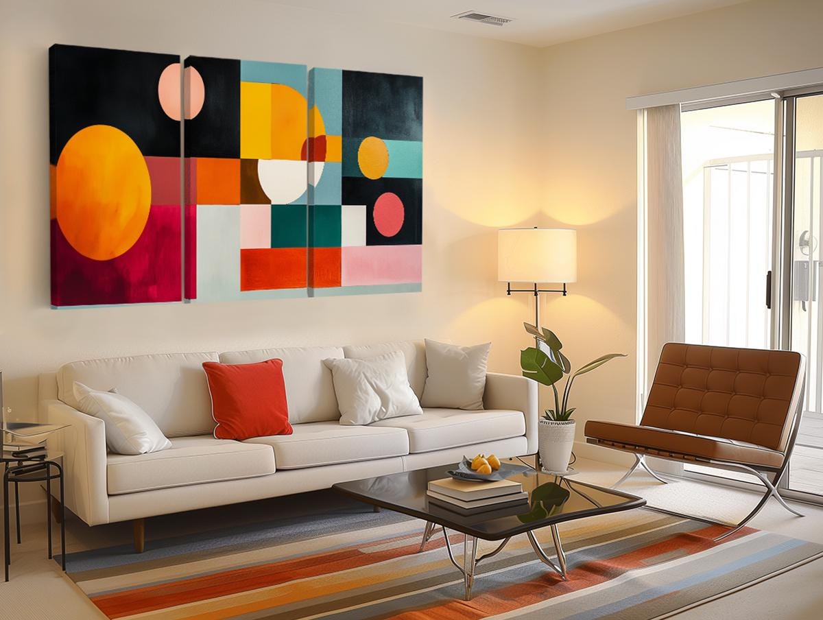 a living room filled with furniture and a painting on the wall