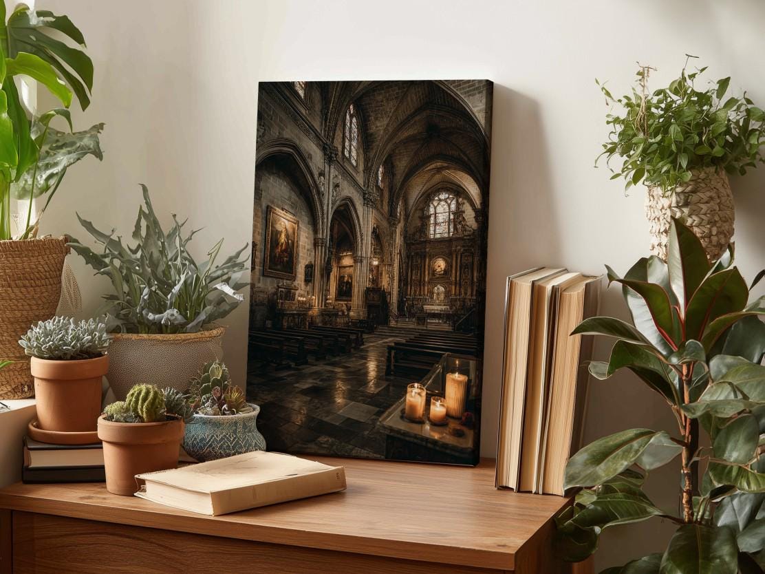 a wooden desk with a framed photograph of a church interior, surrounded by various potted plants and books.