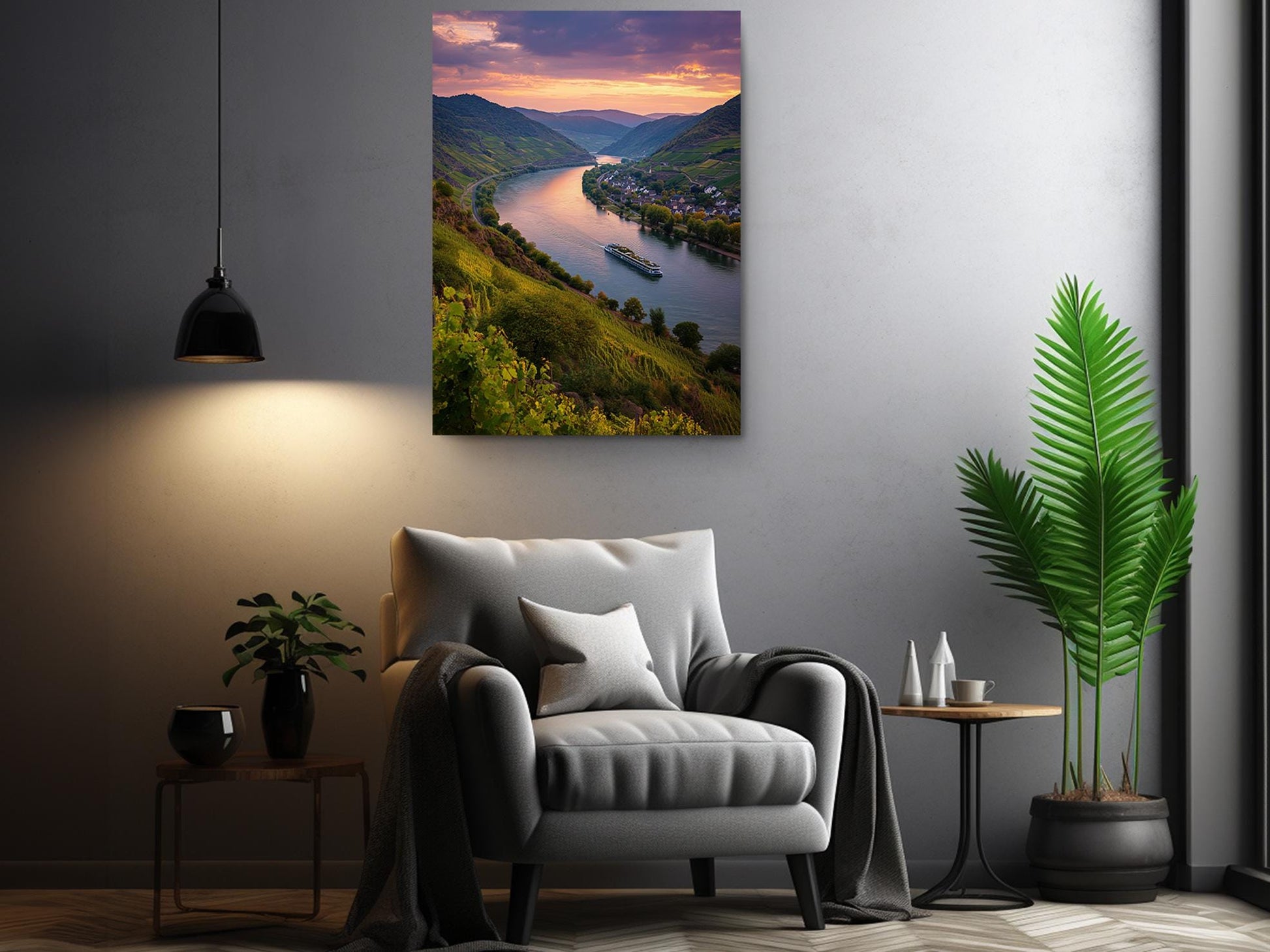 a cozy living room with a comfortable gray armchair, a small side table, and a potted plant. Above the armchair, there is a large framed picture depicting a scenic view of a river with a boat on the water, surrounded by mountains and lush greenery.