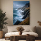 a serene living room with a large painting of a cliff overlooking the ocean hanging on the wall. The painting captures the rugged beauty of the rocky coastline and the vast expanse of the sea. The room is decorated with a comfortable sofa, a wooden coffee table, and two potted plants, creating a cozy and inviting atmosphere.