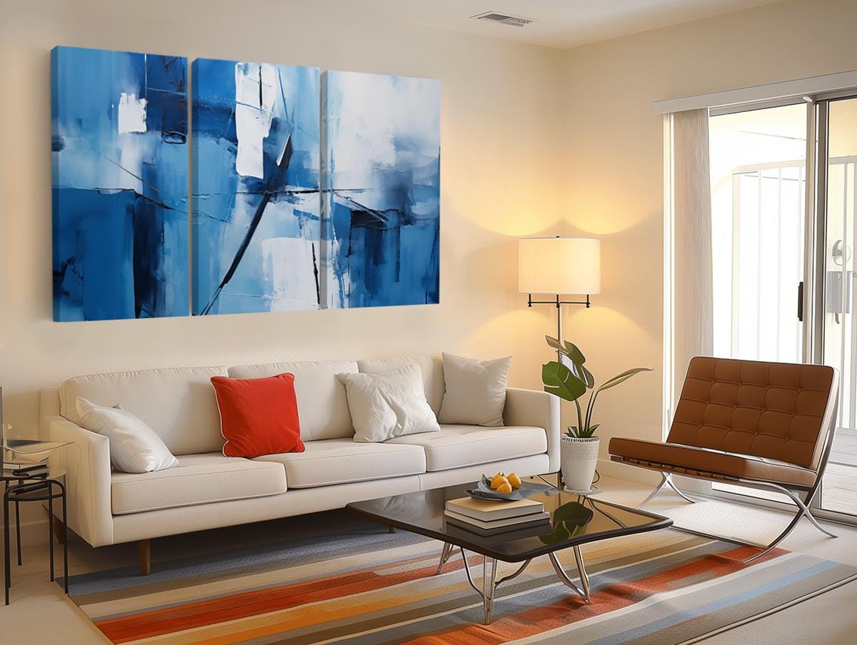 a living room filled with furniture and a painting on the wall