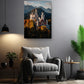 a living room with a gray armchair, a potted plant, and a painting of a castle on the wall.
