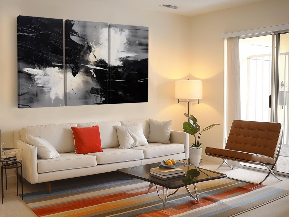 a living room filled with furniture and a painting on the wall
