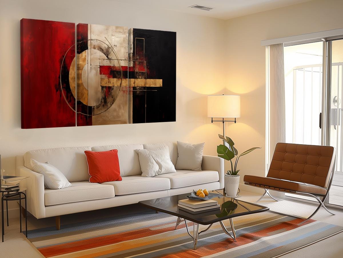a living room with a white couch and a painting on the wall