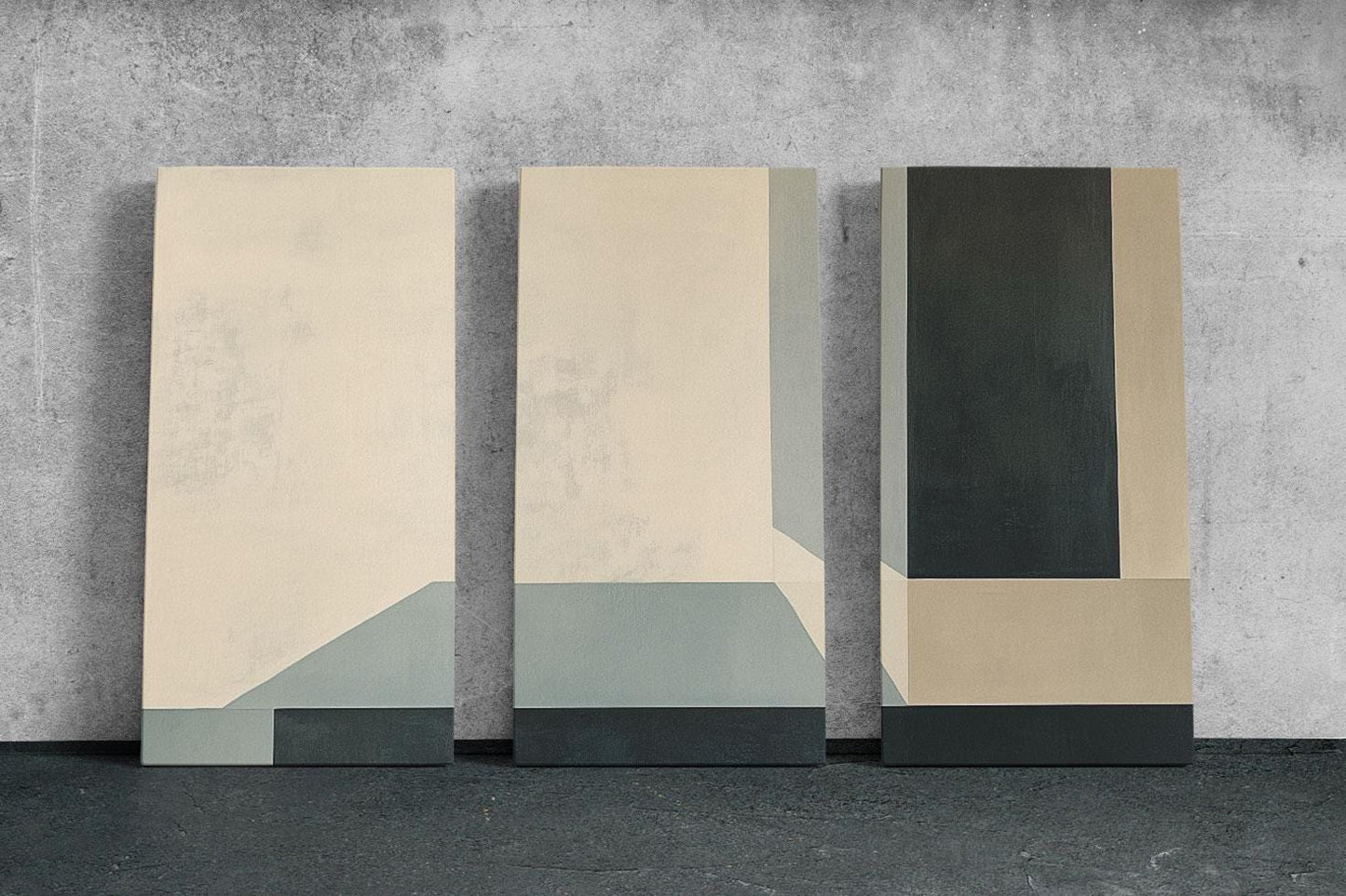 three abstract paintings on a concrete wall