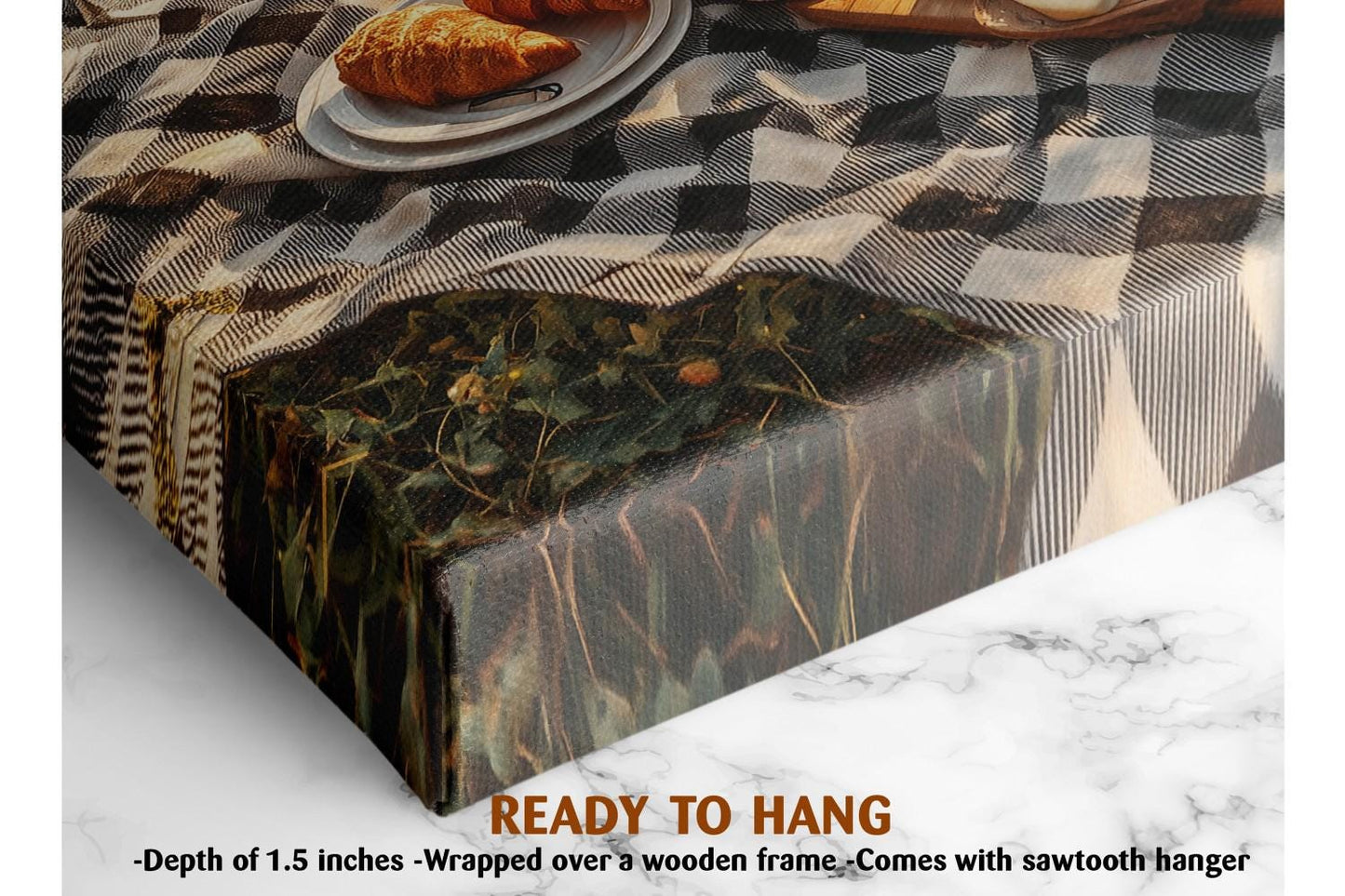 The image is a close-up of a tablecloth with a croissant on a plate, and there is a wooden frame visible. The text below the image reads &quot;READY TO HANG&quot; and &quot;Depth of 1.5 inches - Wrapped over a wooden frame - Comes with sawtooth hanger&quot;.
