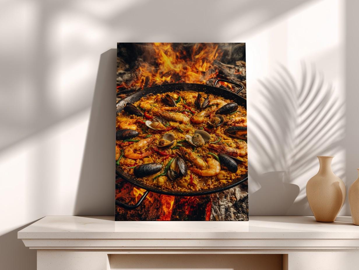 A framed photograph of a paella dish with seafood, including shrimp, mussels, and clams, cooking over a fire.