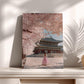 A woman in a pink dress stands in front of a traditional Korean temple with cherry blossom trees in the background.
