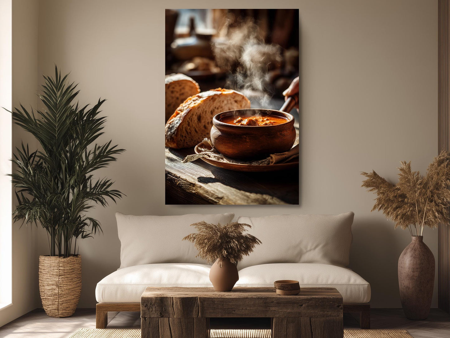 a cozy living room with a large wooden coffee table in the center, surrounded by a white sofa and a potted plant. Above the sofa, there is a framed photograph of a bowl of soup on a wooden surface, with steam rising from it.