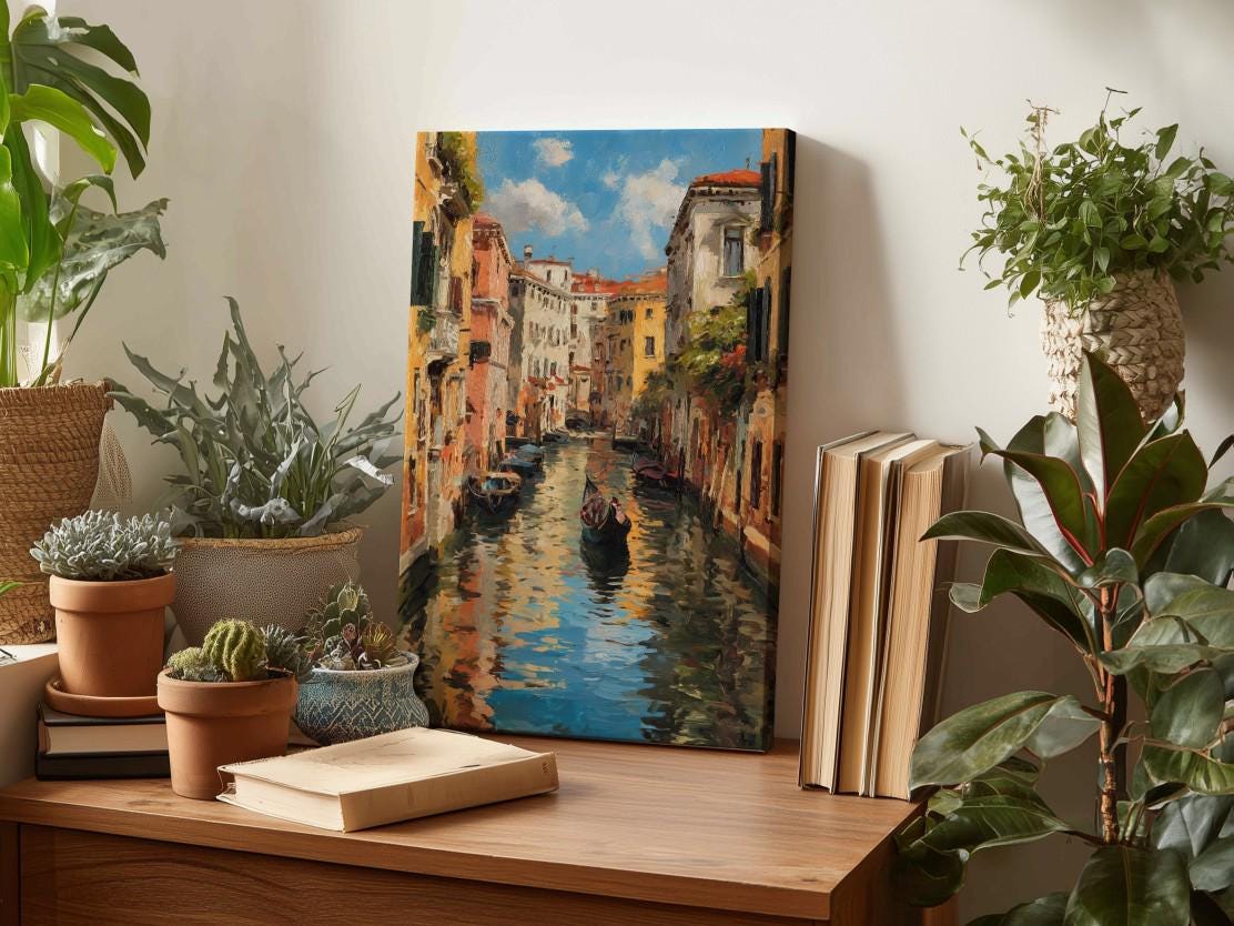 a wooden table with a painting of a canal scene, surrounded by potted plants and books.