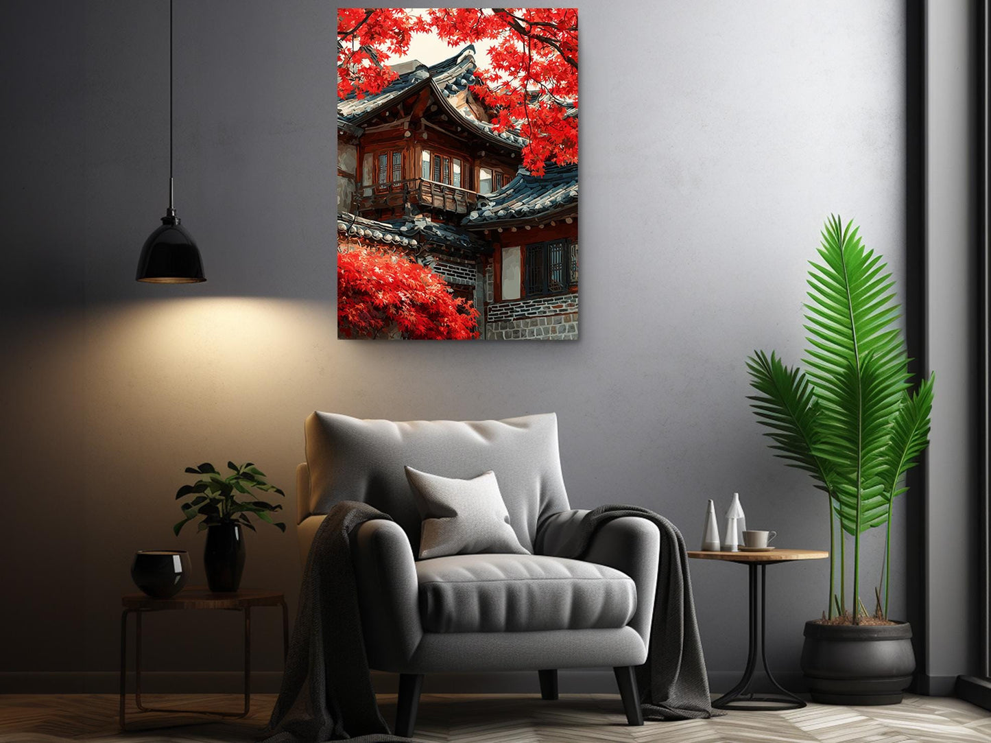 a modern living room with a gray armchair, a potted plant, and a framed picture of a traditional Japanese temple with red autumn foliage.