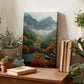a wooden desk with a framed landscape photograph of a mountainous, forested area with a misty, hazy atmosphere. The desk also has several potted plants, books, and other decorative items.