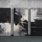 three black and white paintings on a wall