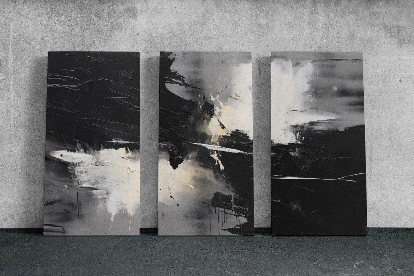 three black and white paintings on a wall