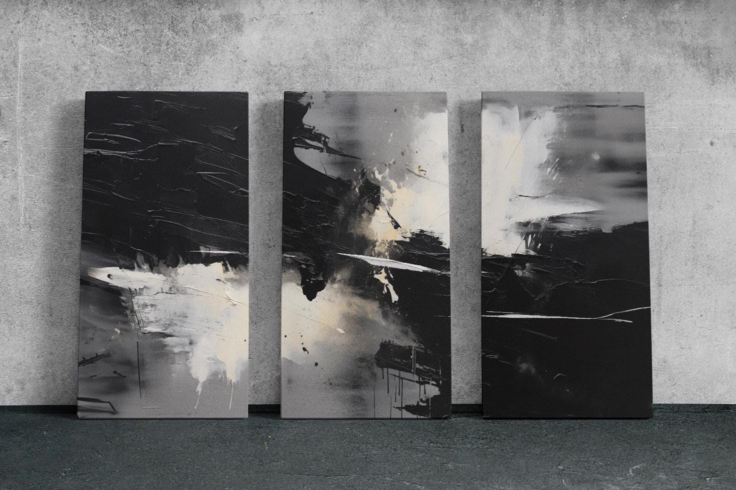 three black and white paintings on a wall